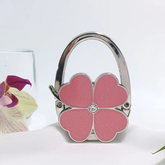 Gancho Plegable para Bolso de Mujer | Colgador Portátil con Diseño de Trébol de Cuatro Hojas | Soporte Elegante y Duradero para Mesa